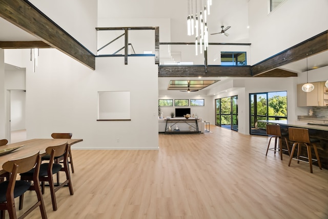 3973 Kalakaua Pl, Princeville, HI 96722 - dining area with a towering ceiling, ceiling fan, light wood-style floors, beam ceiling, and baseboards