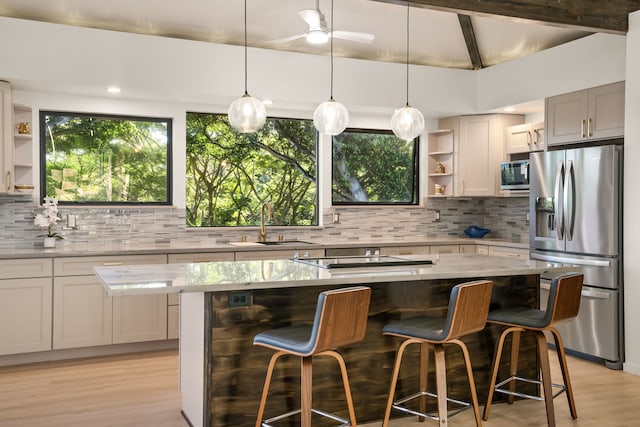 3973 Kalakaua Pl, Princeville, HI 96722 - kitchen with appliances with stainless steel finishes, open shelves, backsplash, a center island, and light wood finished floors