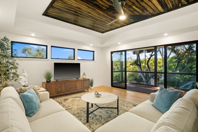 3973 Kalakaua Pl, Princeville, HI 96722 - living area with a tray ceiling, light wood-type flooring, baseboards, recessed lighting, and ceiling fan