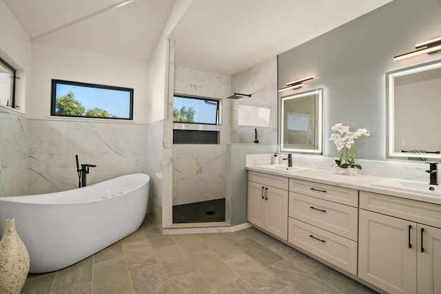 3973 Kalakaua Pl, Princeville, HI 96722 - full bath featuring a marble finish shower, double vanity, a freestanding bath, tile walls, and wainscoting