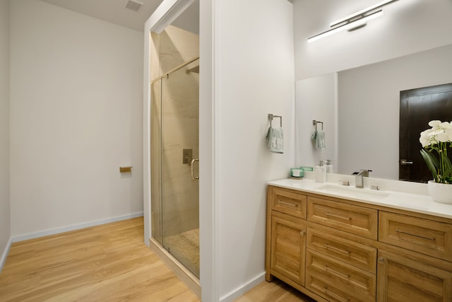 3973 Kalakaua Pl, Princeville, HI 96722 - bathroom with vanity, a stall shower, wood finished floors, and baseboards