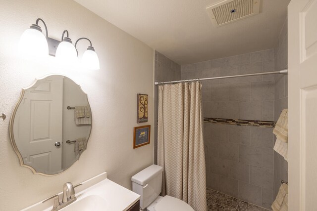 75-6081 Alii Dr Unit O103, Kailua-Kona, HI 96740 - bathroom featuring toilet, vanity, and a tile shower