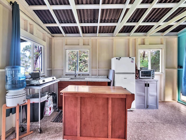 87-1081 Haleili Rd, Captain Cook, HI 96704 - kitchen featuring freestanding refrigerator, a center island, and a sink
