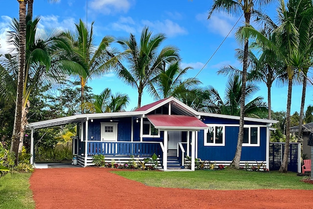 12-266 Mapuana Ave, Pahoa, HI 96778 - view of front facade featuring covered porch, driveway, a carport, a front yard, and metal roof