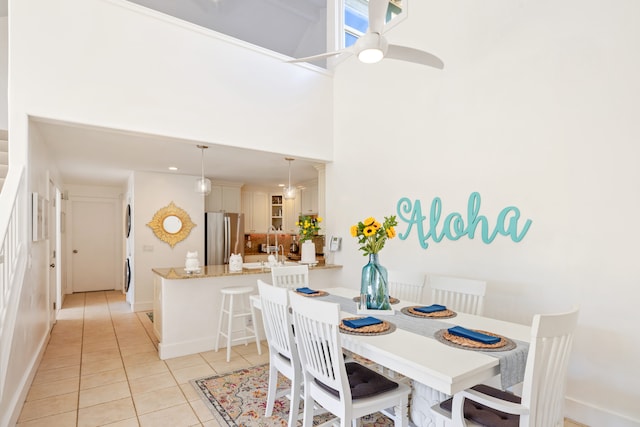 1831 Poipu Rd Unit 720, Koloa, HI 96756 - dining space featuring light tile patterned flooring, a high ceiling, baseboards, and ceiling fan