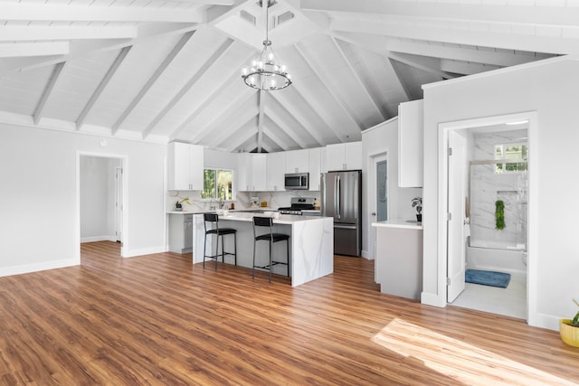 15-1632 6th Ave, Keaau, HI 96749 - kitchen featuring stainless steel appliances, a kitchen island, a kitchen bar, a chandelier, and white cabinetry