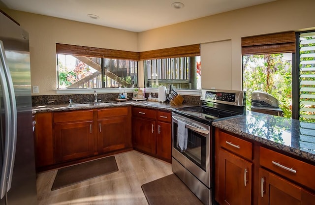 3920 Wyllie Rd Unit 9A, Princeville, HI 96722 - kitchen with stainless steel appliances, a sink, dark stone countertops, light wood finished floors, and recessed lighting
