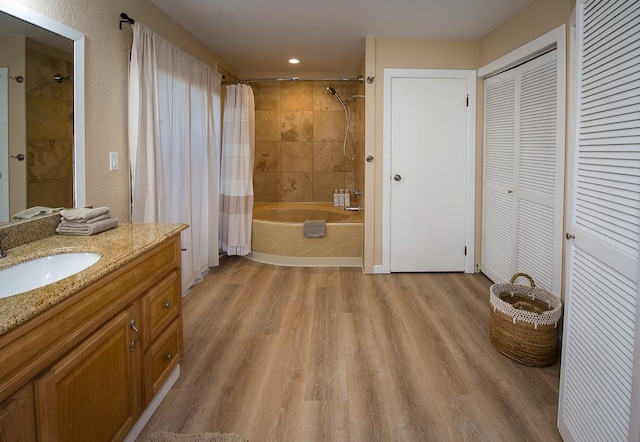 3920 Wyllie Rd Unit 9A, Princeville, HI 96722 - bathroom with wood finished floors, shower / tub combo with curtain, vanity, a closet, and recessed lighting
