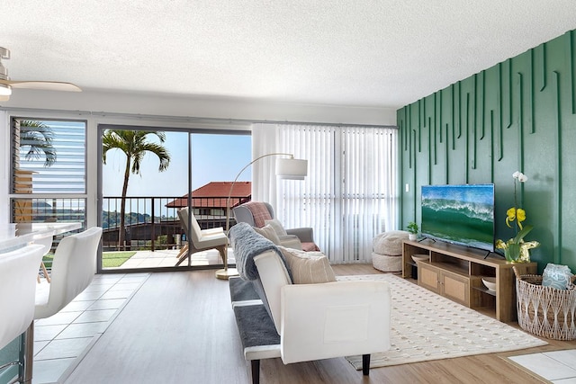 79-7199 Mamalahoa Hwy Unit 247, Holualoa, HI 96725 - living room featuring a textured ceiling, wood finished floors, and plenty of natural light