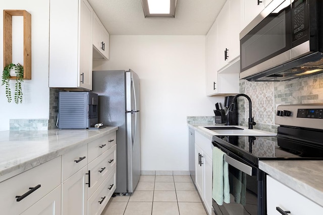79-7199 Mamalahoa Hwy Unit 247, Holualoa, HI 96725 - kitchen with appliances with stainless steel finishes, a sink, tasteful backsplash, white cabinetry, and light stone countertops