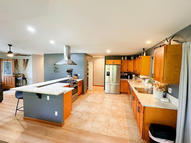 15-2804 Maiko St, Pahoa, HI 96778 - kitchen featuring appliances with stainless steel finishes, wall chimney range hood, a sink, brown cabinets, and a peninsula