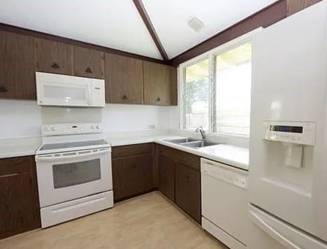 95-337 Pohina Pl, Mililani, HI 96789 - kitchen with white appliances, a sink, light countertops, vaulted ceiling, and dark brown cabinets