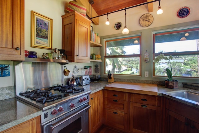 4446 Aku Rd, Hanalei, HI 96714 - kitchen with high end stainless steel range oven, open shelves, brown cabinets, lofted ceiling, and hanging light fixtures