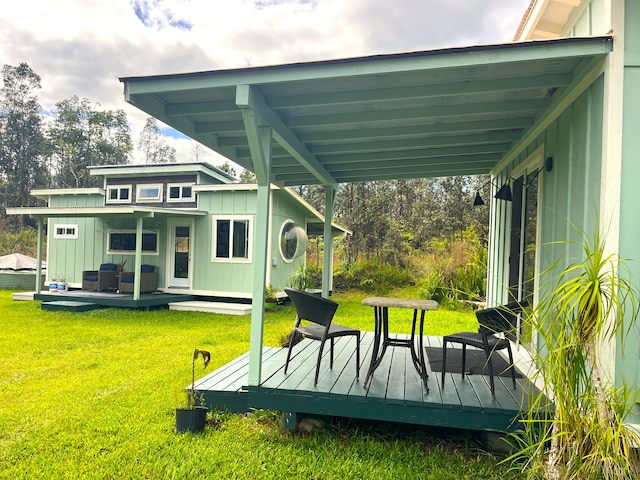 16-2000 Moho Rd, Mountain View, HI 96760 - rear view of property with board and batten siding, a yard, and a wooden deck