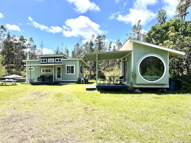 16-2000 Moho Rd, Mountain View, HI 96760 - back of property with board and batten siding, a deck, and a yard