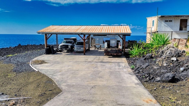 88-127 Kai Ave, Captain Cook, HI 96704 - view of patio with concrete driveway, a carport, and a water view