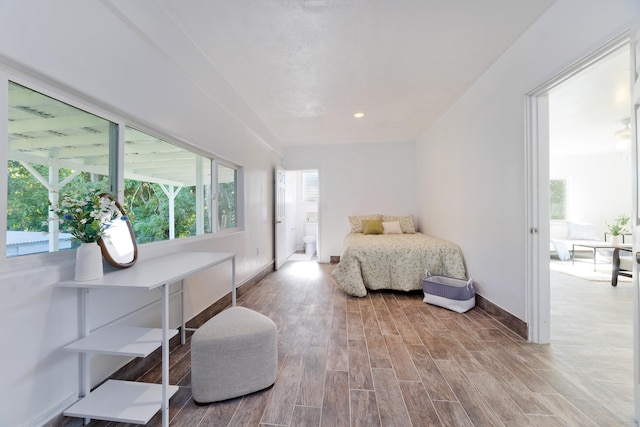 16-1321 Pohaku Cir, Keaau, HI 96749 - bedroom featuring wood finished floors, baseboards, and connected bathroom