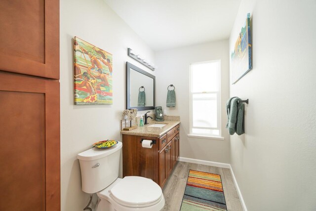 15-885 Paradise Ala Kai Dr, Keaau, HI 96749 - half bath featuring vanity, wood finished floors, toilet, and baseboards