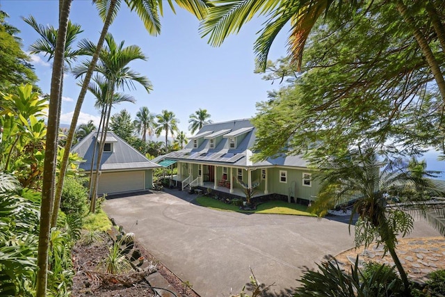 82-5957 Wakida Dr, Captain Cook, HI 96704 - view of front of property with covered porch, an outbuilding, metal roof, a detached garage, and driveway