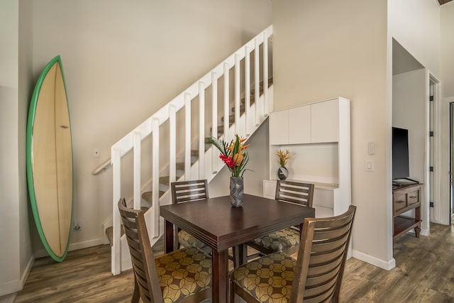 3811 Edward Rd Unit 2310, Princeville, HI 96722 - dining space featuring dark wood finished floors, baseboards, and stairs