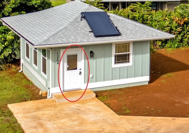 1264-D Crossley Rd, Kapaa, HI 96746 - view of front of property with a shingled roof, board and batten siding, and a chimney