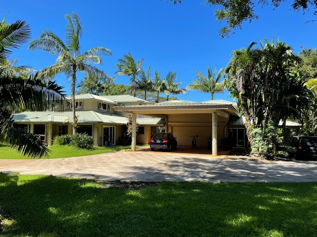 5-2841 Kuhio Hwy Unit A, Kilauea, HI 96754 - view of front of house with a garage, concrete driveway, an attached carport, a front yard, and metal roof