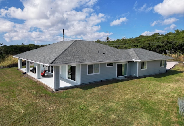 94-5774 Kalakau St, Naalehu, HI 96772 - rear view of house with a patio, roof with shingles, and a yard