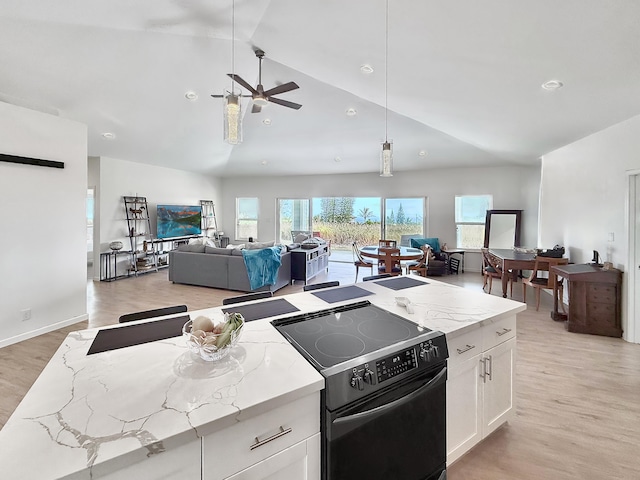 94-5774 Kalakau St, Naalehu, HI 96772 - kitchen with black / electric stove, light stone countertops, white cabinetry, decorative light fixtures, and high vaulted ceiling