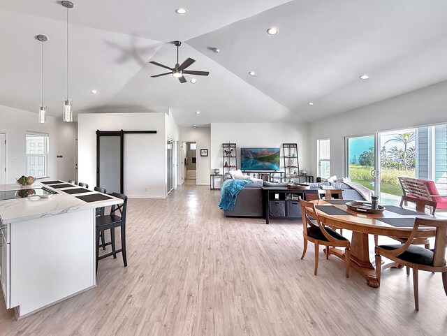 94-5774 Kalakau St, Naalehu, HI 96772 - dining room with a barn door, high vaulted ceiling, light wood finished floors, ceiling fan, and recessed lighting