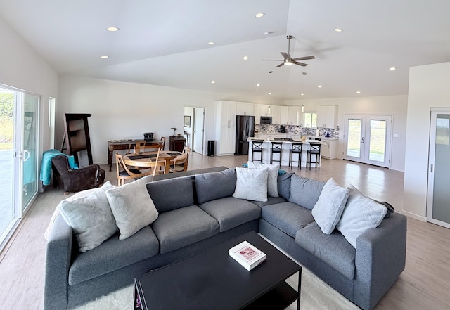 94-5774 Kalakau St, Naalehu, HI 96772 - living room with lofted ceiling, plenty of natural light, light wood-style floors, a ceiling fan, and recessed lighting