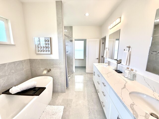 94-5774 Kalakau St, Naalehu, HI 96772 - bathroom with tiled shower, double vanity, a soaking tub, tile walls, and recessed lighting