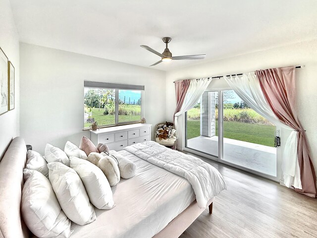 94-5774 Kalakau St, Naalehu, HI 96772 - bedroom with access to exterior, light wood finished floors, and ceiling fan