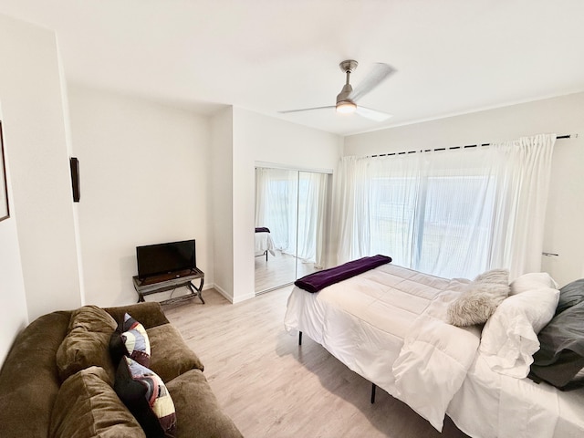94-5774 Kalakau St, Naalehu, HI 96772 - bedroom with light wood-type flooring, access to outside, a ceiling fan, and baseboards