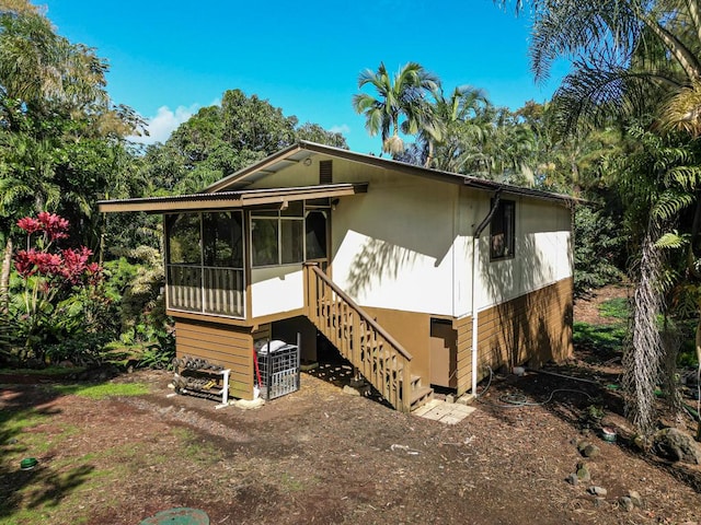 15-2024 19th Ave, Keaau, HI 96749 - view of front of house featuring stairway and a sunroom