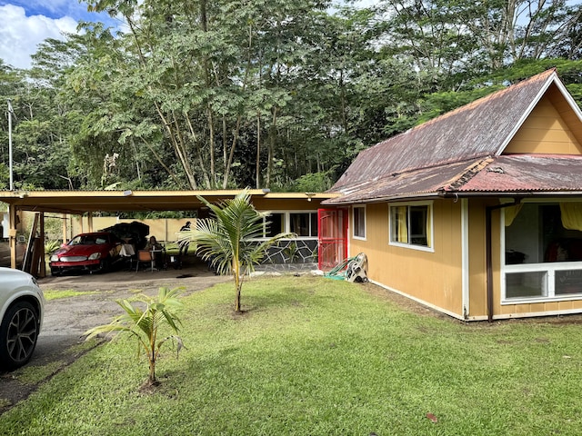 14-810 Cholet Cir, Pahoa, HI 96778 - view of front of house featuring a front yard, asphalt driveway, metal roof, and a carport