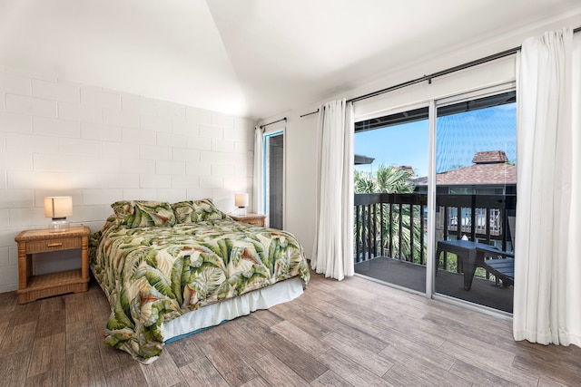 75-5855 Walua Rd Unit 15, Kailua-Kona, HI 96740 - bedroom with access to exterior, wood finished floors, and concrete block wall