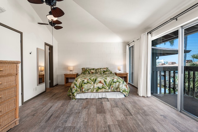 75-5855 Walua Rd Unit 15, Kailua-Kona, HI 96740 - bedroom featuring access to outside, wood finished floors, concrete block wall, and vaulted ceiling