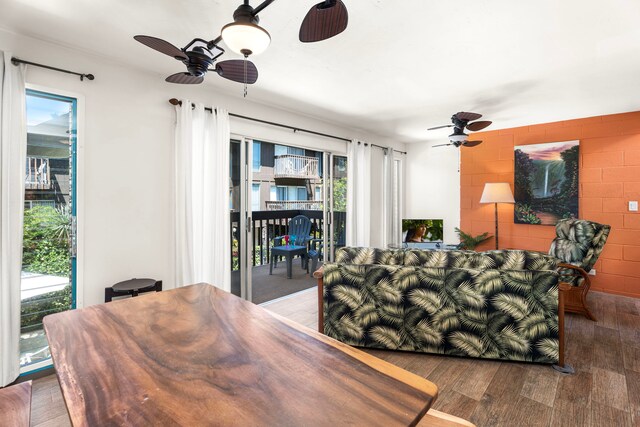 75-5855 Walua Rd Unit 15, Kailua-Kona, HI 96740 - living room featuring a ceiling fan, wood finished floors, and concrete block wall