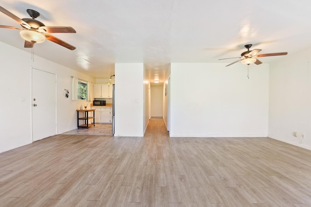 15-2737 Lai St, Pahoa, HI 96778 - unfurnished living room featuring ceiling fan, light wood-style flooring, and baseboards