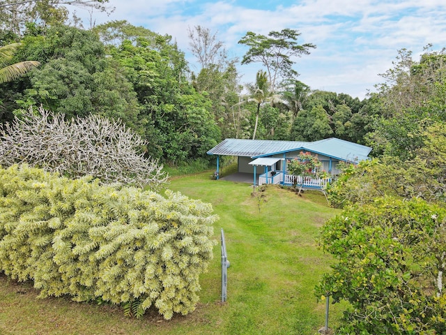 15-2737 Lai St, Pahoa, HI 96778 - view of green lawn with an attached carport and a deck