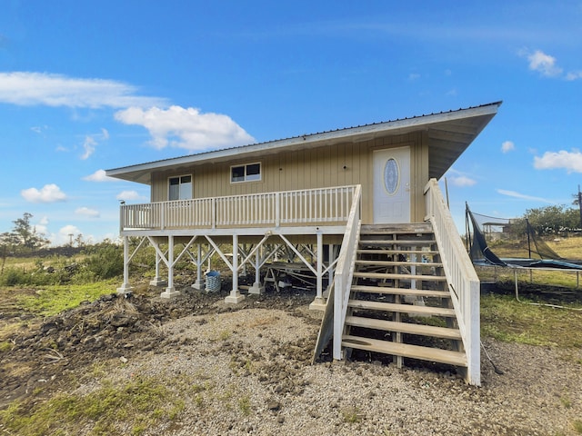 92-8685 Paradise Pkwy, Ocean View, HI 96737 - back of house with a trampoline, metal roof, and stairway