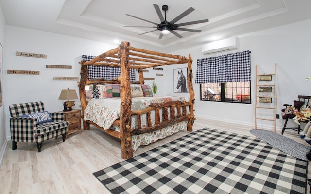15-1462 13th Ave, Keaau, HI 96749 - bedroom with a raised ceiling, a wall unit AC, light wood finished floors, baseboards, and ceiling fan