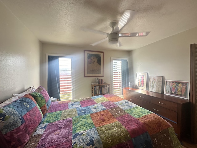 4461 Kamoa Rd Unit D12, Kapaa, HI 96746 - bedroom featuring a textured ceiling, multiple windows, and ceiling fan