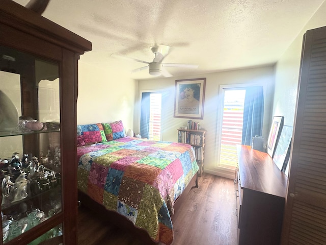 4461 Kamoa Rd Unit D12, Kapaa, HI 96746 - bedroom with a textured ceiling, wood finished floors, and a ceiling fan