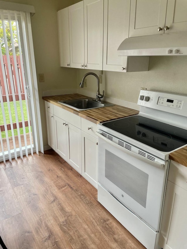 4461 Kamoa Rd Unit D12, Kapaa, HI 96746 - kitchen featuring white electric range, under cabinet range hood, wood counters, a sink, and light wood-style flooring