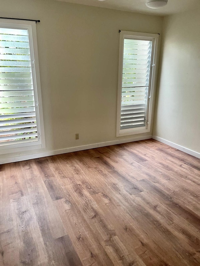 4461 Kamoa Rd Unit D12, Kapaa, HI 96746 - spare room with plenty of natural light, wood finished floors, and baseboards