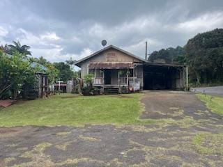 36-2642 Old Mamalahoa Hwy, Ookala, HI 96774 - view of front facade with asphalt driveway, a front yard, and a carport