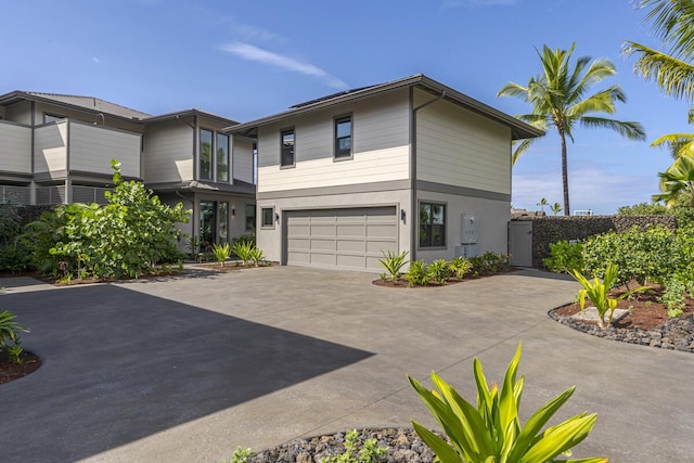 73-4780 Hinahina Rd Unit 24, Kailua-Kona, HI 96740 - modern home with an attached garage, driveway, and stucco siding