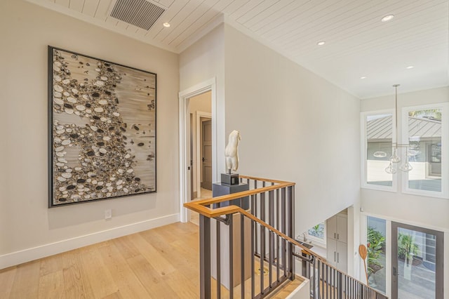 73-4780 Hinahina Rd Unit 24, Kailua-Kona, HI 96740 - hallway with an upstairs landing, light wood-type flooring, recessed lighting, baseboards, and a chandelier