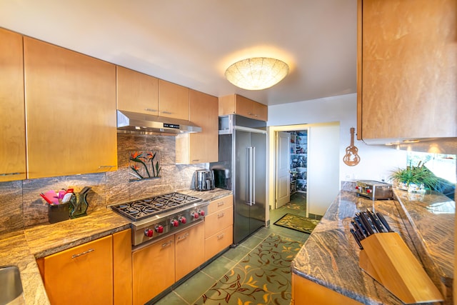 78-6928 Walua Rd, Kailua-Kona, HI 96740 - kitchen featuring under cabinet range hood, stainless steel gas cooktop, high quality fridge, tasteful backsplash, and light stone countertops